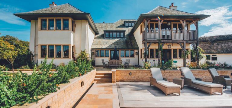 garden featuring a natural stone wall and stone paving